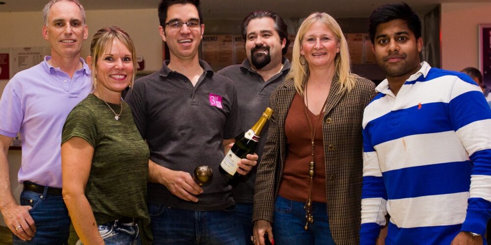 jennings team holding bottle of champagne celebrating